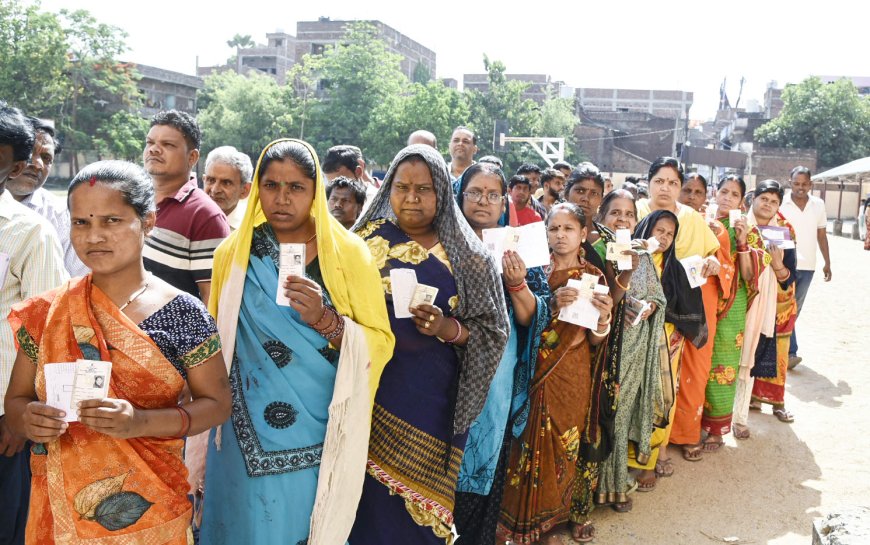 Voters displaying identity cards while standing in the queue to cast their votes at a polling booth  Gaya